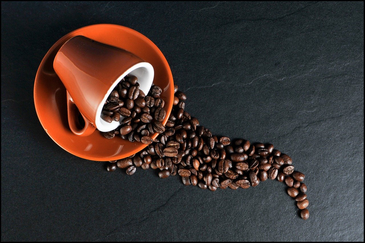 coffee cup with beans spilling out